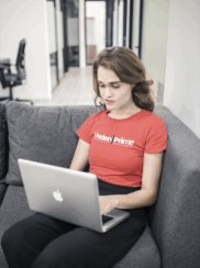 woman-working-on-a-laptop-wearing-a-t-shirt-mockup-at-the-office-a20508